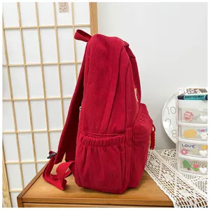Red corduroy backpack detail view, cute mini school bag for casual daily shopping.