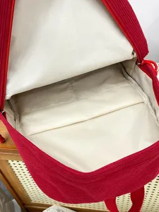 Red corduroy mini backpack with spacious interior and soft lining for daily casual use.