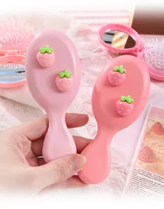 Cute pink strawberry air cushion hair massage comb for cute daily hair care and styling.