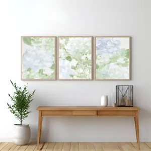 Detailed view of a modern 3-panel abstract floral canvas art framed, styled over a wooden console.