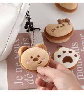 Cute milk coffee plush animal keychain detail close-up, soft cartoon bag pendant charm.