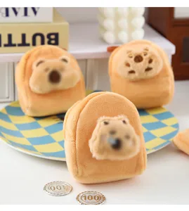 Close-up detail of cute capybara plush coin purse, soft yellow material, mini portable storage bag.