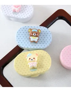 Close-up detail of cute cartoon bear contact lens case, polka dot double box design for eye care.