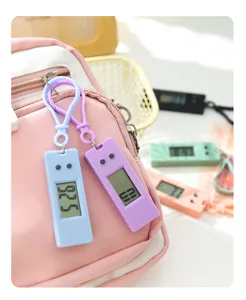 Mini electronic clock keychain detail, portable student digital timer, quiet desk timepiece.
