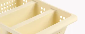Detail of beige plastic shoe storage box organizer with ventilation holes, durable home bin.