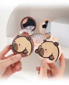 Portable folding cushion hair brush with cute cartoon capybara design for daily use.