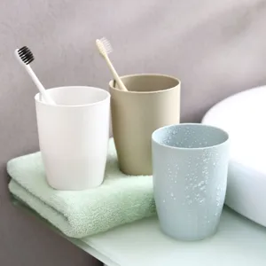 Minimalist plastic toothbrush cups set, solid color bathroom gargle cups for family use.