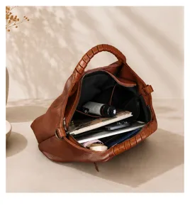 Detail view of vintage brown genuine leather tote bag showing soft texture and spacious interior.