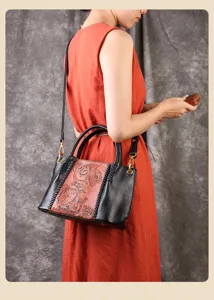 Detailed view of vintage carved leather handbag with dual handles and braided side accent.