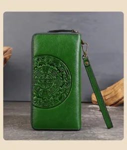 Vintage green genuine cowhide leather long wallet with embossed pattern and wrist strap.