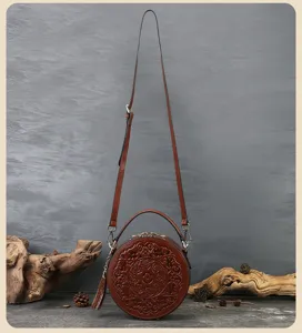 Retro embossed round leather handbag, vintage single shoulder crossbody bag with details.