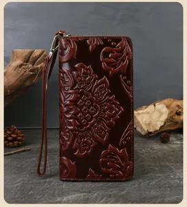 Detail view of the vintage floral embossed cowhide leather wallet showing exquisite texture.