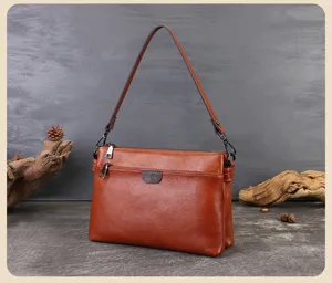 Genuine leather shoulder bag for women, stylish multi-layer commuter handbag in brown.