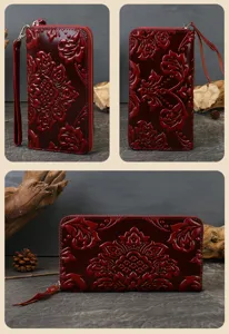 Burgundy genuine leather long zip wallet with exquisite embossed floral pattern and wrist strap.