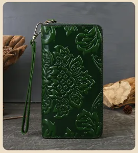 Dark green embossed genuine leather wallet detail, featuring retro floral patterns and wrist strap.