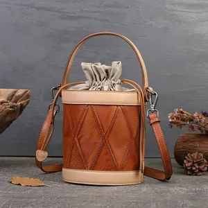 Detailed shot of vintage leather bucket bag, showing diamond patchwork texture and drawstring.