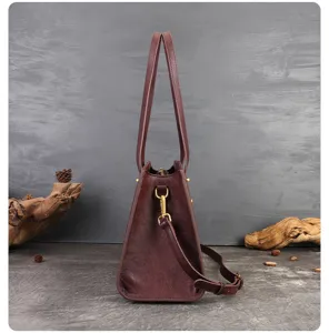 Detailed side view of dark brown leather handbag showcasing fine stitching and hardware.