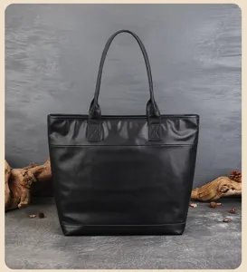 Black leather tote bag detail showing durable stitching and large capacity for daily commuting.
