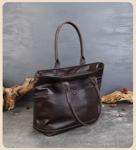 Close-up of vintage brown leather tote bag showing fine leather texture and front pocket.