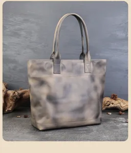 Close-up view of vintage genuine leather tote bag showing rich brush-off texture and sturdy handles.