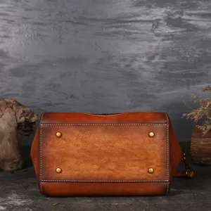 Vintage genuine leather women shoulder bag with embossed design and metal feet for daily use.