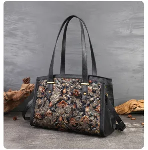 Detailed view of women's vintage floral embroidered shoulder bag with leather trim and handles.