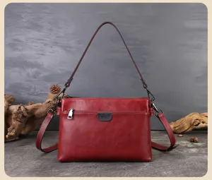 Detailed view of red leather women shoulder bag, multi-layer crossbody bag for daily commute.