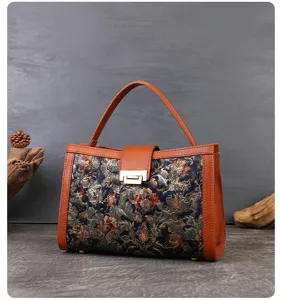 Close-up detail shot of the vintage floral embroidered handbag showing exquisite fabric texture.