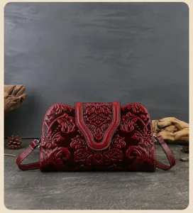 Vintage embossed leather evening handbag, detailed floral pattern, perfect for events.