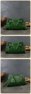 Detailed view of dark green embossed genuine leather evening handbag, vintage style clutch.