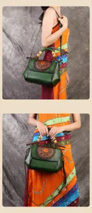 Retro embossed leather shoulder bag with bamboo handle and exquisite floral flap design.