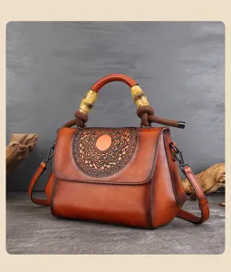 Vintage embossed leather crossbody handbag with bamboo handle and boho floral mandala design.