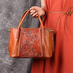 Vintage genuine leather tote bag with hand-carved floral patterns and braided handles.