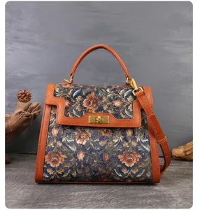 Vintage floral embroidered handbag with brown leather splicing and top handle for women.