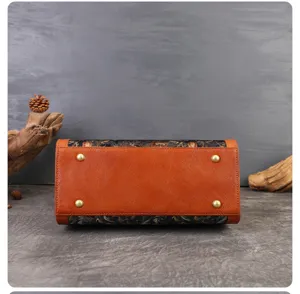 Retro floral embroidery genuine leather handbag bottom detail view, elegant commuting women bag.