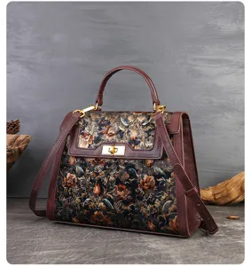 Close-up detail of vintage floral embroidered leather handbag with elegant turn-lock closure.