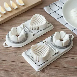 Multifunctional egg slicer with stainless steel wires for cutting boiled eggs and duck eggs.
