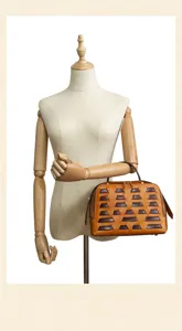 Vintage vegetable-tanned leather dumpling handbag with geometric block design for women.