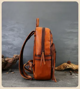 Vintage genuine leather backpack side view showing retro distressed texture and pockets.