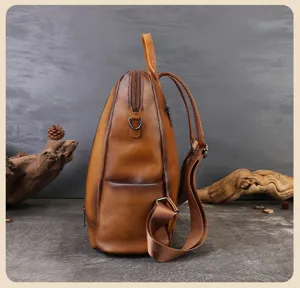 Detailed side view of brown leather women backpack with adjustable straps and zipper closure.