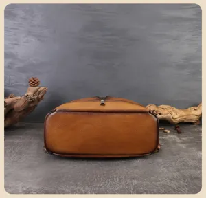 Detailed view of casual retro brown leather women's backpack, fine stitching and texture.