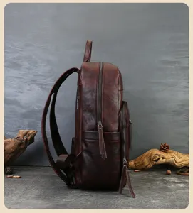 Vintage genuine leather backpack side detail view, dark brown cowhide casual travel bag.