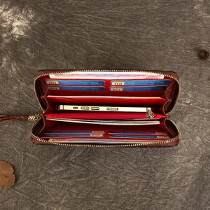 Vintage brown leather zip-around long wallet for women with multi-card slots and red lining.