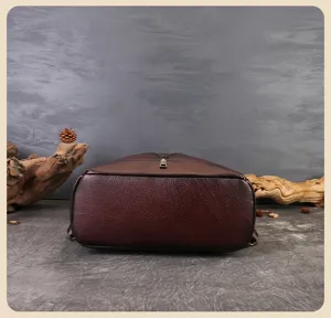 Dark brown leather backpack bottom detail shot with vintage rustic wood props setup for women