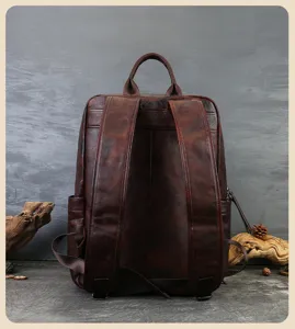 Detail view of the vintage genuine leather backpack showing fine leather texture.