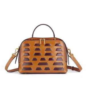 Retro vegetable-tanned leather dumpling handbag featuring a stylish top handle and crossbody strap.