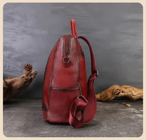 Red leather casual backpack detail view, stylish large capacity commuting school bag.