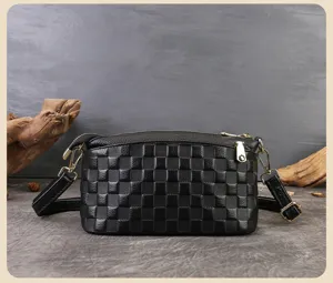 Borsa a tracolla nera in pelle con motivo a quadri classico e dettagli dorati.