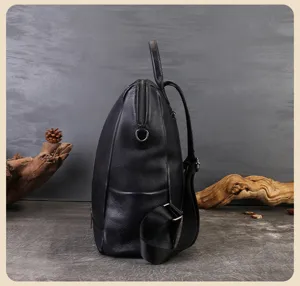 Side detail view of a sleek black leather backpack showcasing durable zippers and straps.
