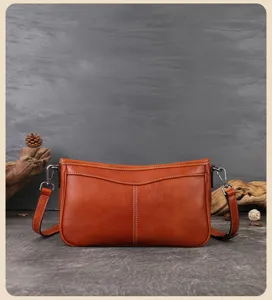 Vintage brown leather underarm bag for women, retro baguette shoulder bag, daily chic accessory.